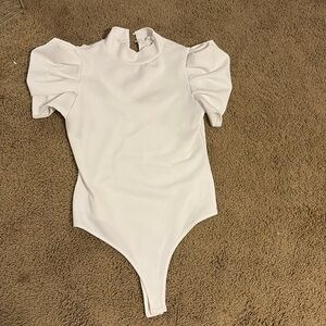 This is a white bodysuit with ruffle sleeves